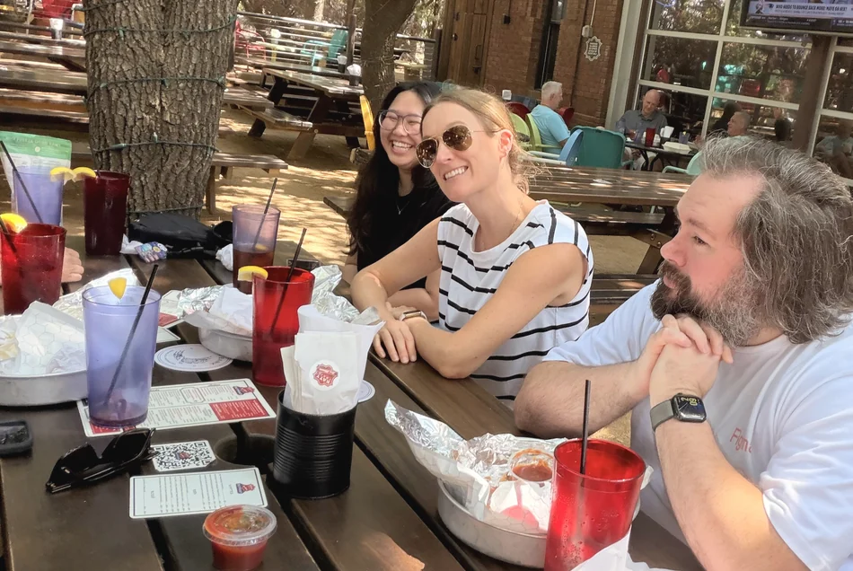 The team round a table on a restaurant patio