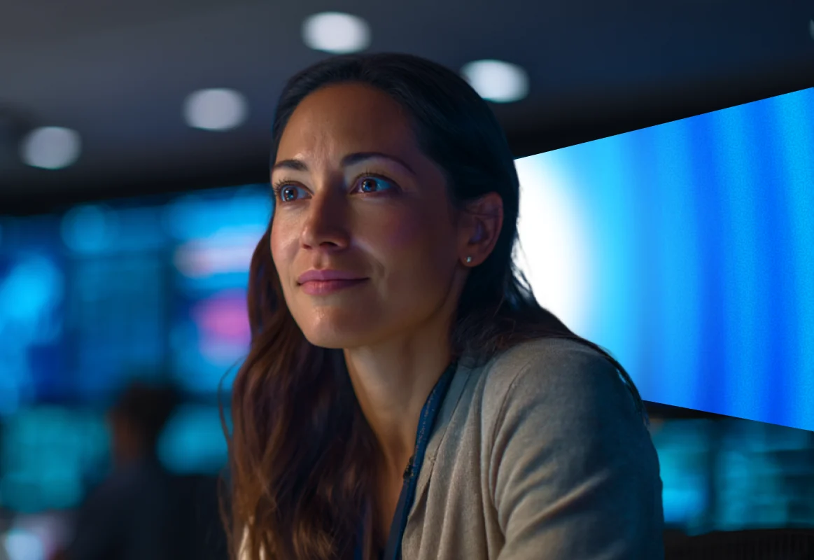 A nuHarbor analyst in front of a wall of screens